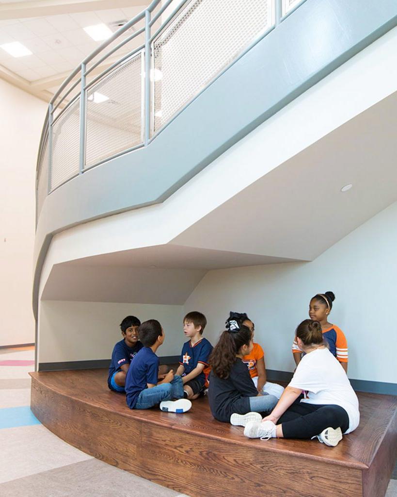 Students sitting under staircase inside Library inside Jim and Pam Wells Elementary School in Cypress